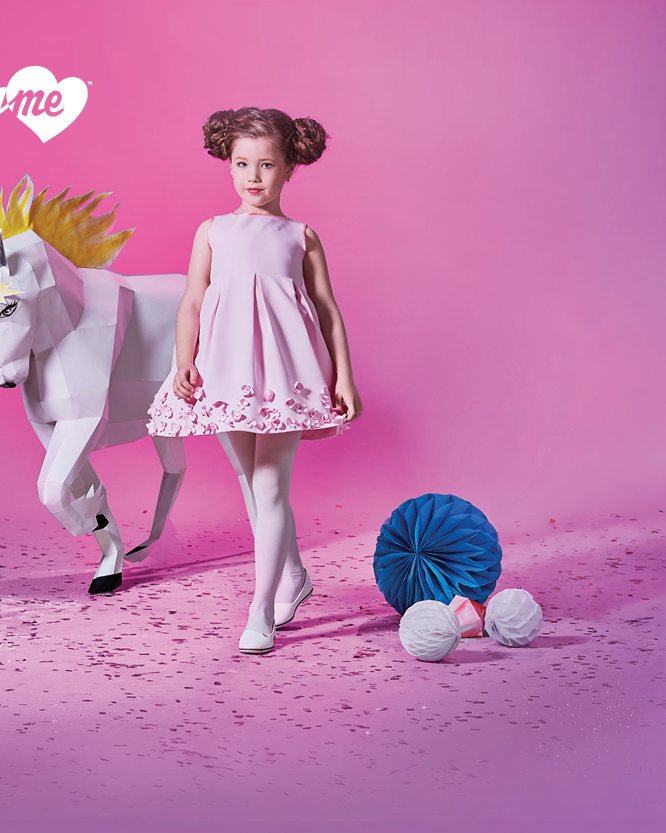 A girl walking beside a paper unicorn, Pretty Me brand banner