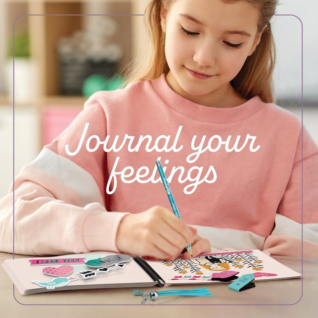 A girl decorating her Pretty Me journal